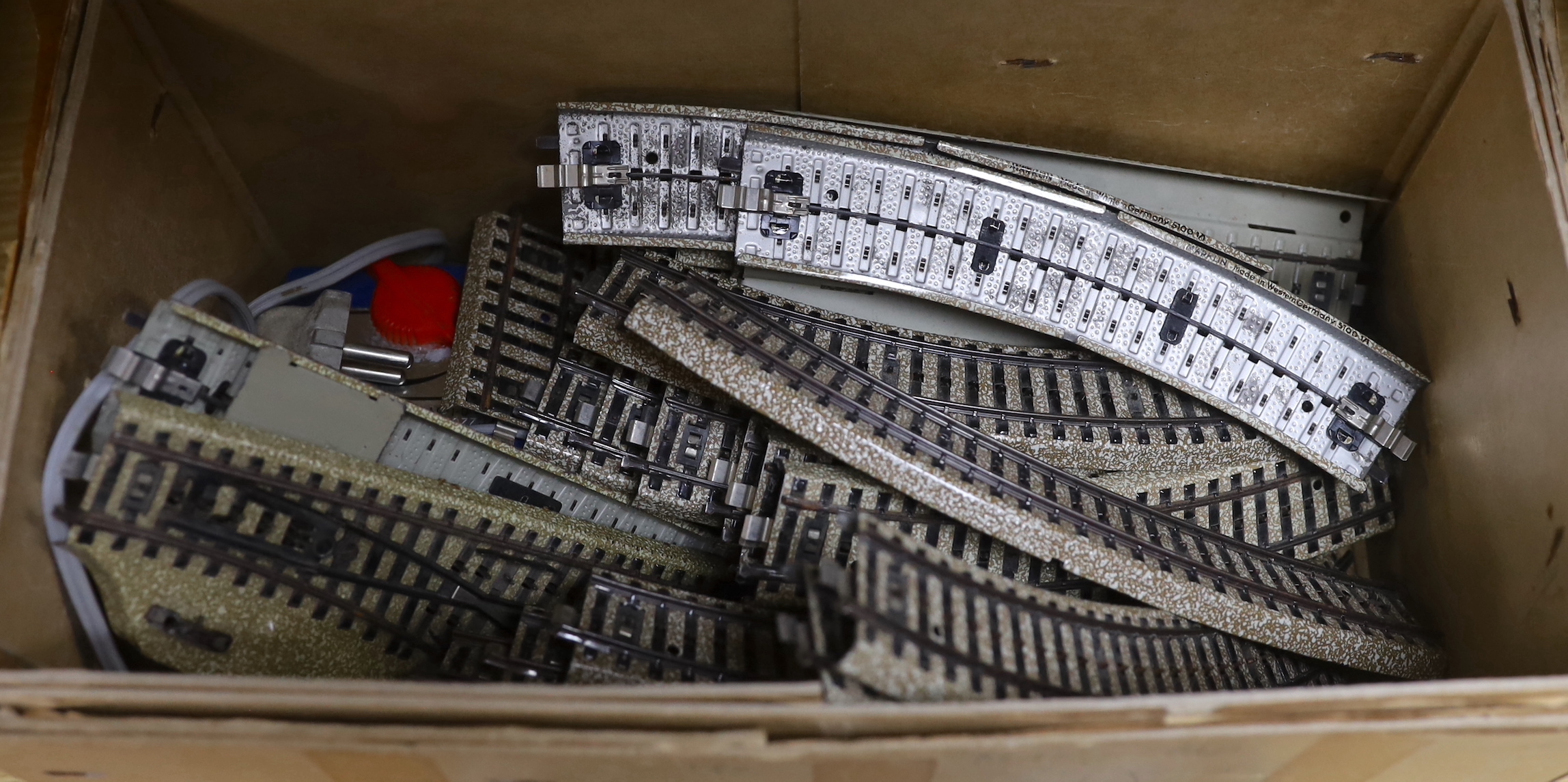 A German Marklin 7390 miniature rail station, tracking, engine and carriages, with original booklet
